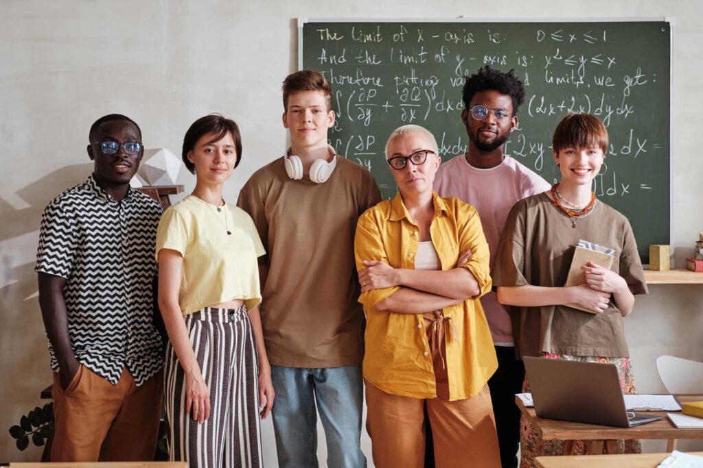 teacher-with-students-standing-in-the-classroom-YNK4UHR.jpg